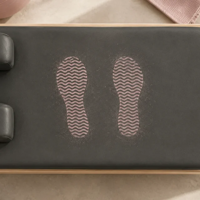 Two chalky sole prints on a reformer carriage